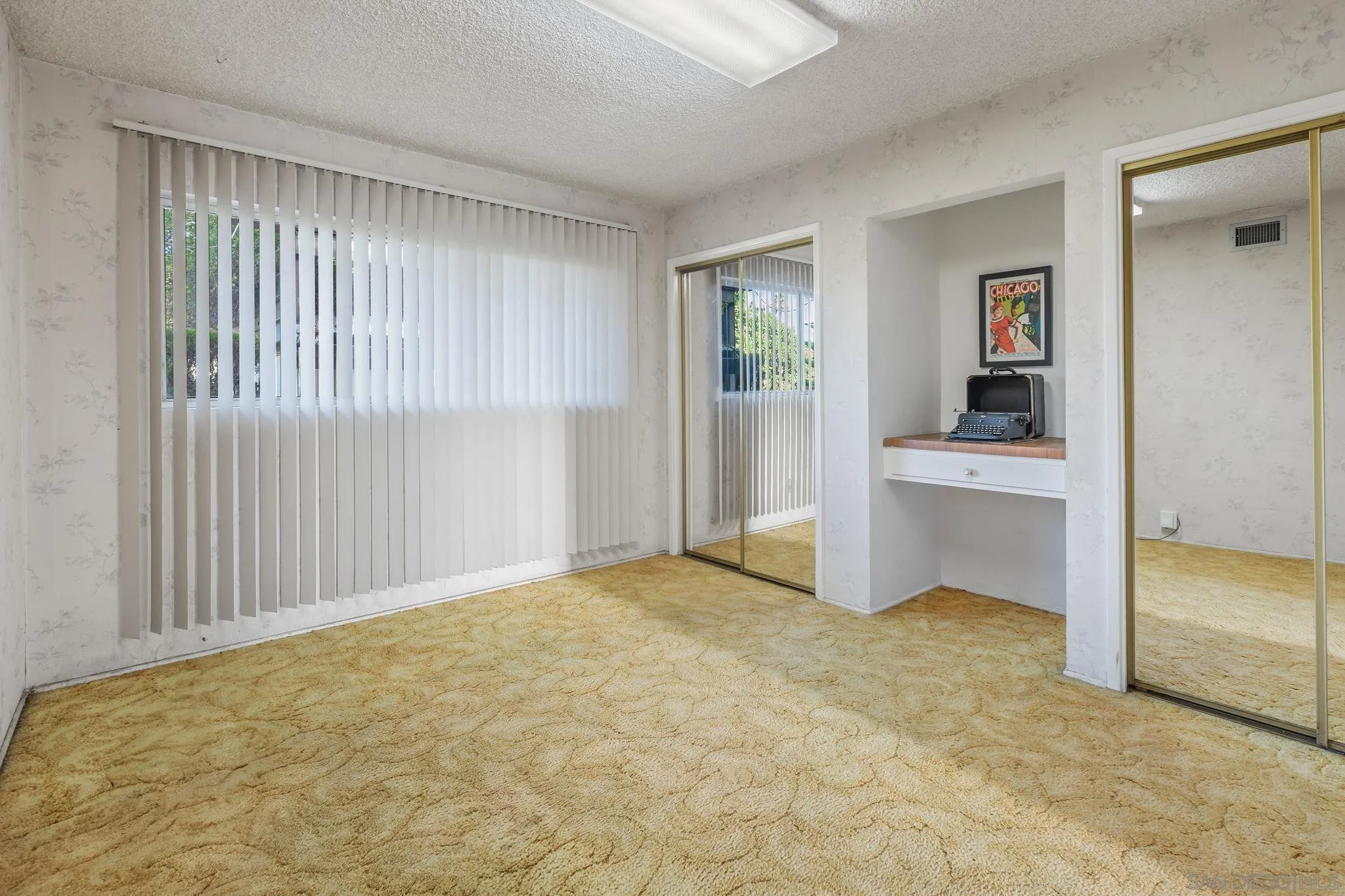 5645 Severin Drive La Mesa, CA 91942 - Photo 18 of 29 an empty room with windows and cabinet