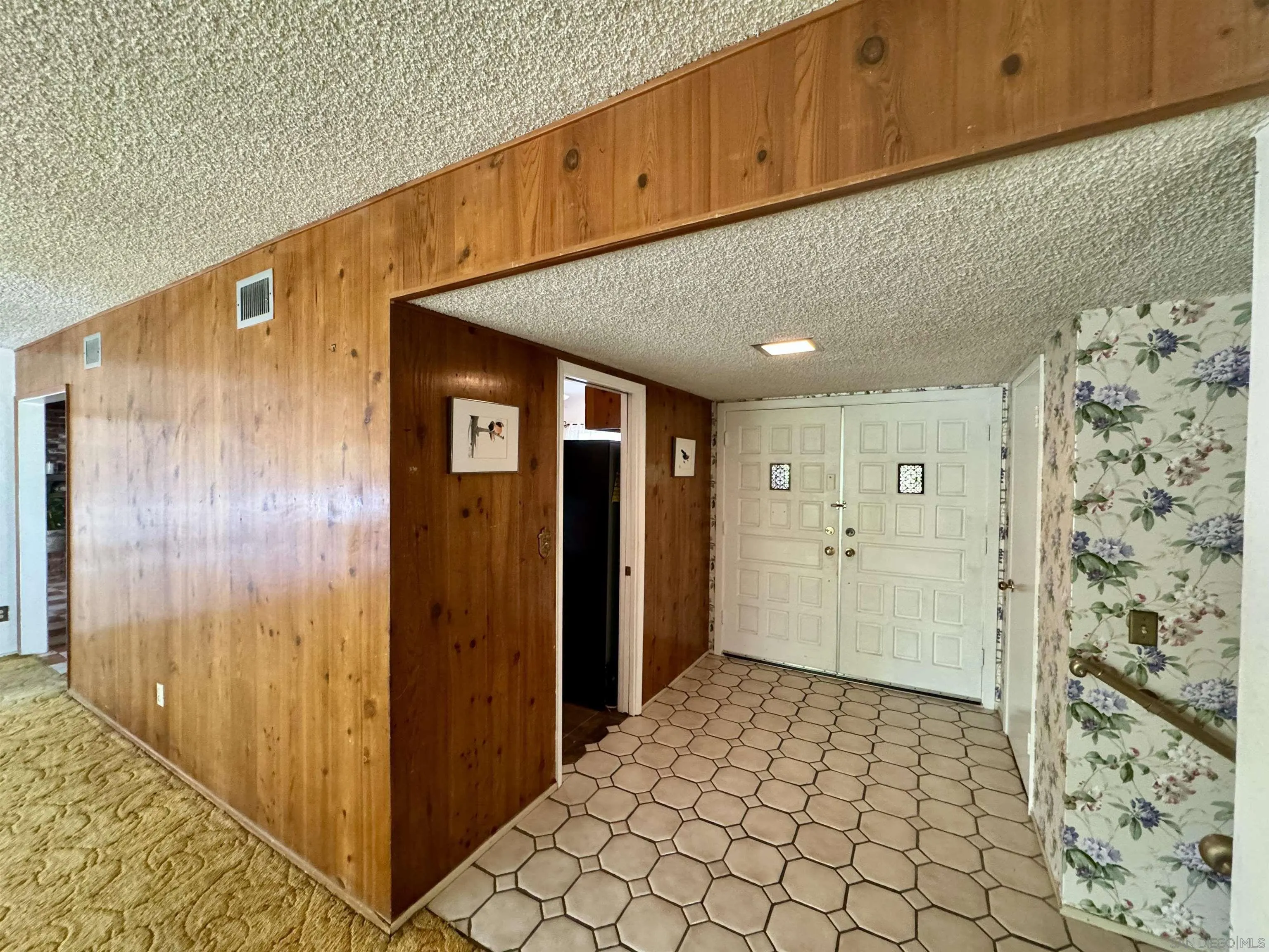 5645 Severin Drive La Mesa, CA 91942 - Photo 10 of 29 a view of a hallway with wooden walls and entryway