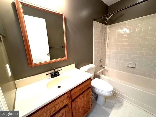 a bathroom with a sink mirror toilet and bathtub