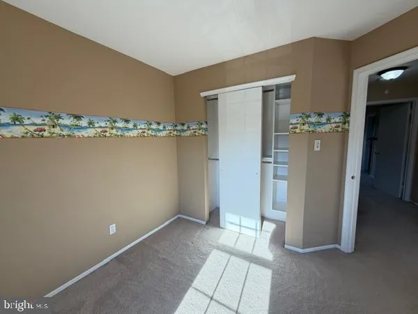 a view of a room with water heater and wooden cabinet