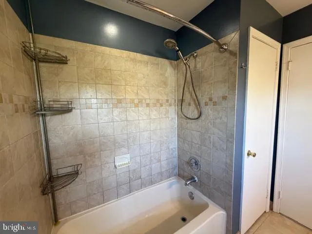 a bathroom with a bath tub and shower