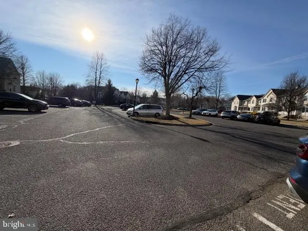 a view of a street with a cars parked on the road