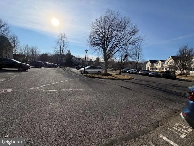 a view of a street with a cars parked on the road