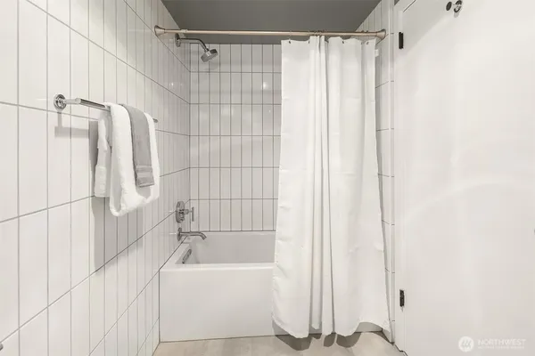 a bathroom with a shower curtain and a bathtub