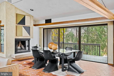 a living room with furniture a fireplace and a large window