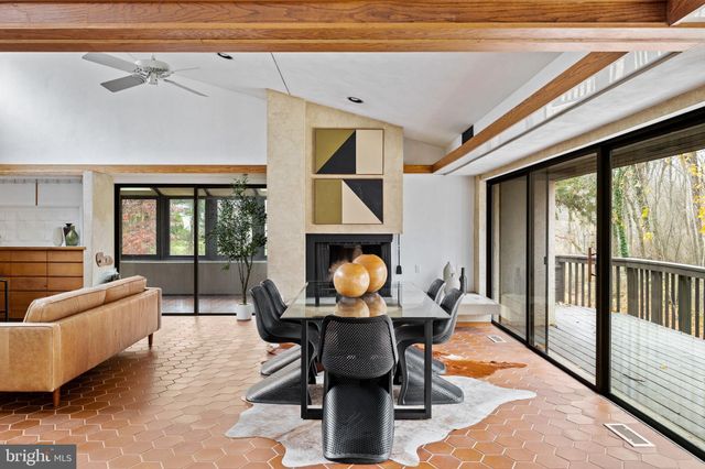 a bedroom with furniture and a large window