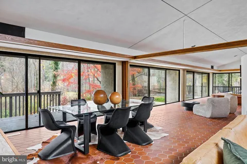 a living room with fireplace furniture and a large window