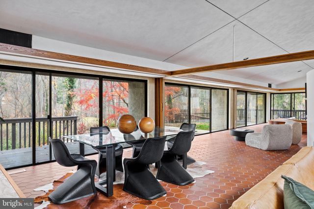 a living room with fireplace furniture and a large window