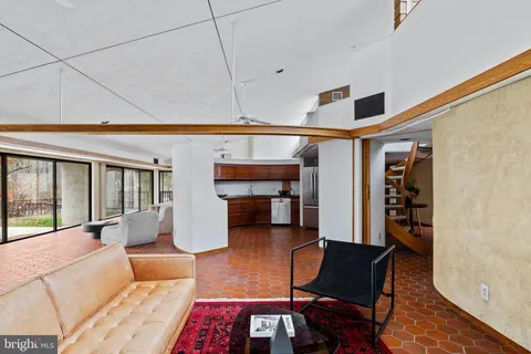 a view of a hallway with a big room and glass door