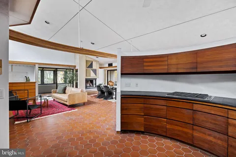 a bathroom with a granite countertop sink a mirror a bathtub and next to a window