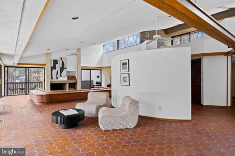 a view of a bedroom with a bed and wooden floor