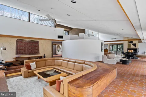 an aerial view of a house with a yard and a large tree