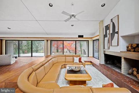 a front view of house with yard and trees in the background