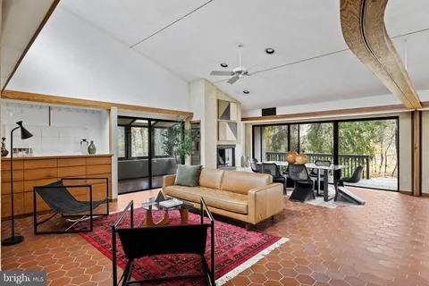 a living room with furniture and large windows