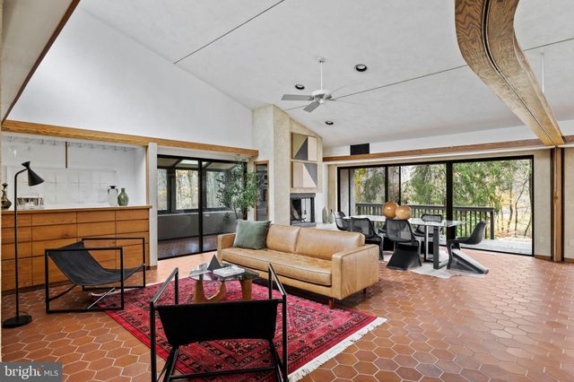 a living room with furniture and large windows