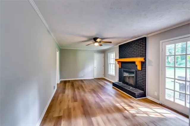 wooden floor in an empty room with a window