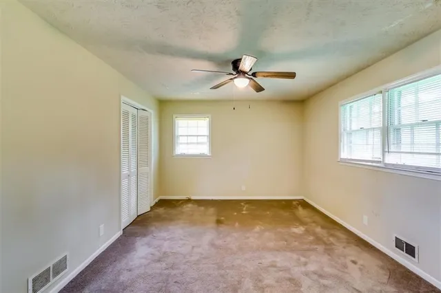 a view of a livingroom with a ceiling fan and window