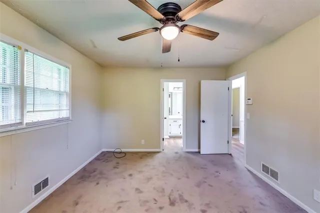 a view of a livingroom with a ceiling fan and window