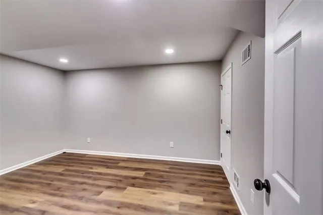 a view of wooden floor and windows in an empty room