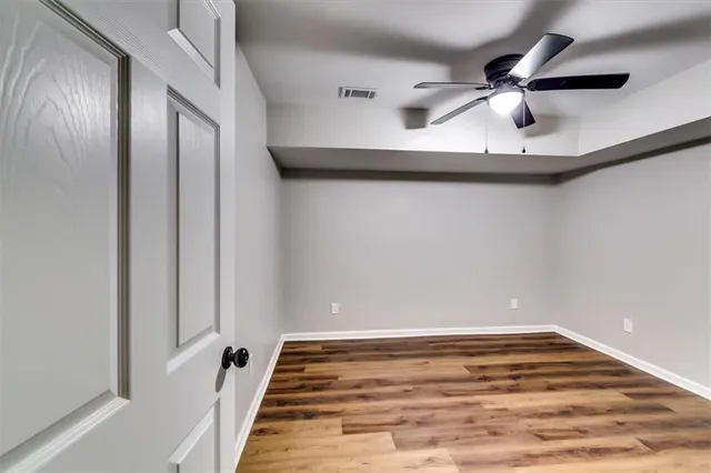 a view of a yard in front of a house with large trees