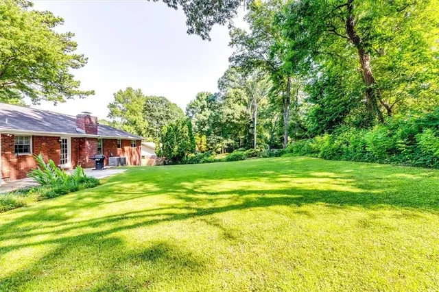 a view of backyard with tub and trees