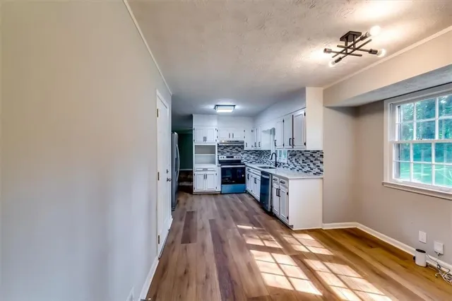 a kitchen with a refrigerator and a sink