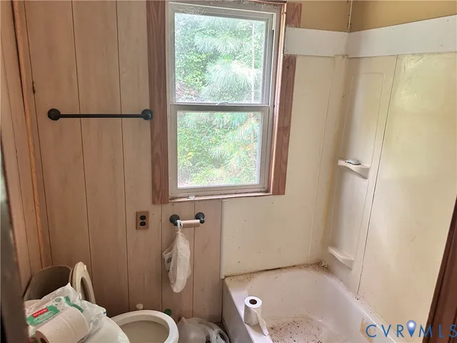 a bathroom with a toilet and shower