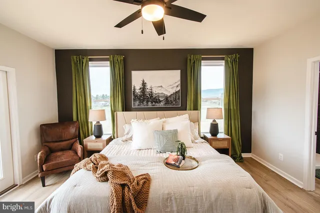 a bedroom with a large bed and a chandelier