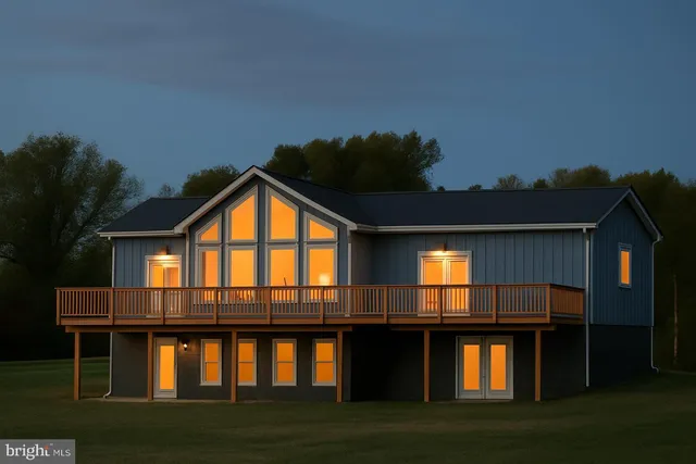 a view of house with yard and deck