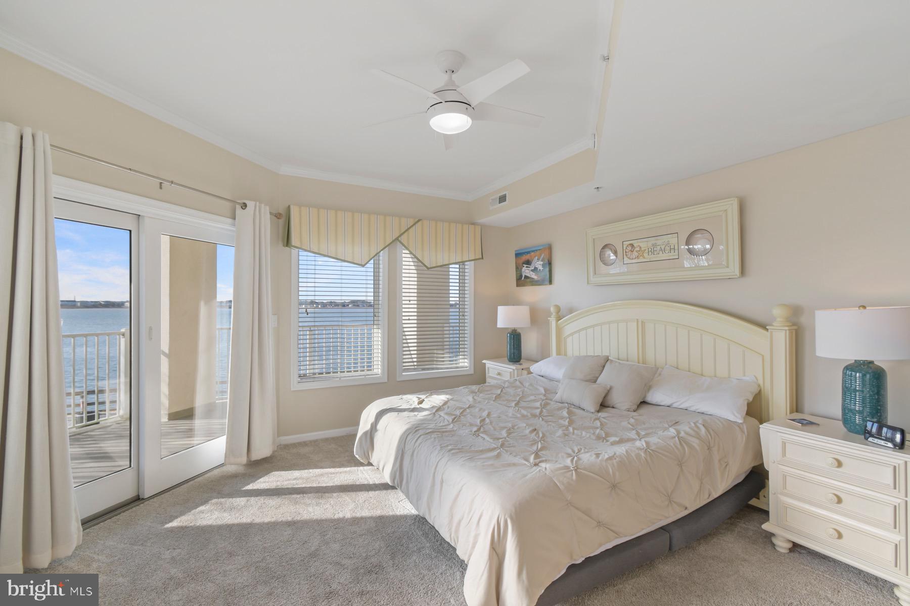 310 2nd Street, Unit 101 Ocean City, MD 21842 - Photo 13 of 37 a bedroom with a large bed and a large window