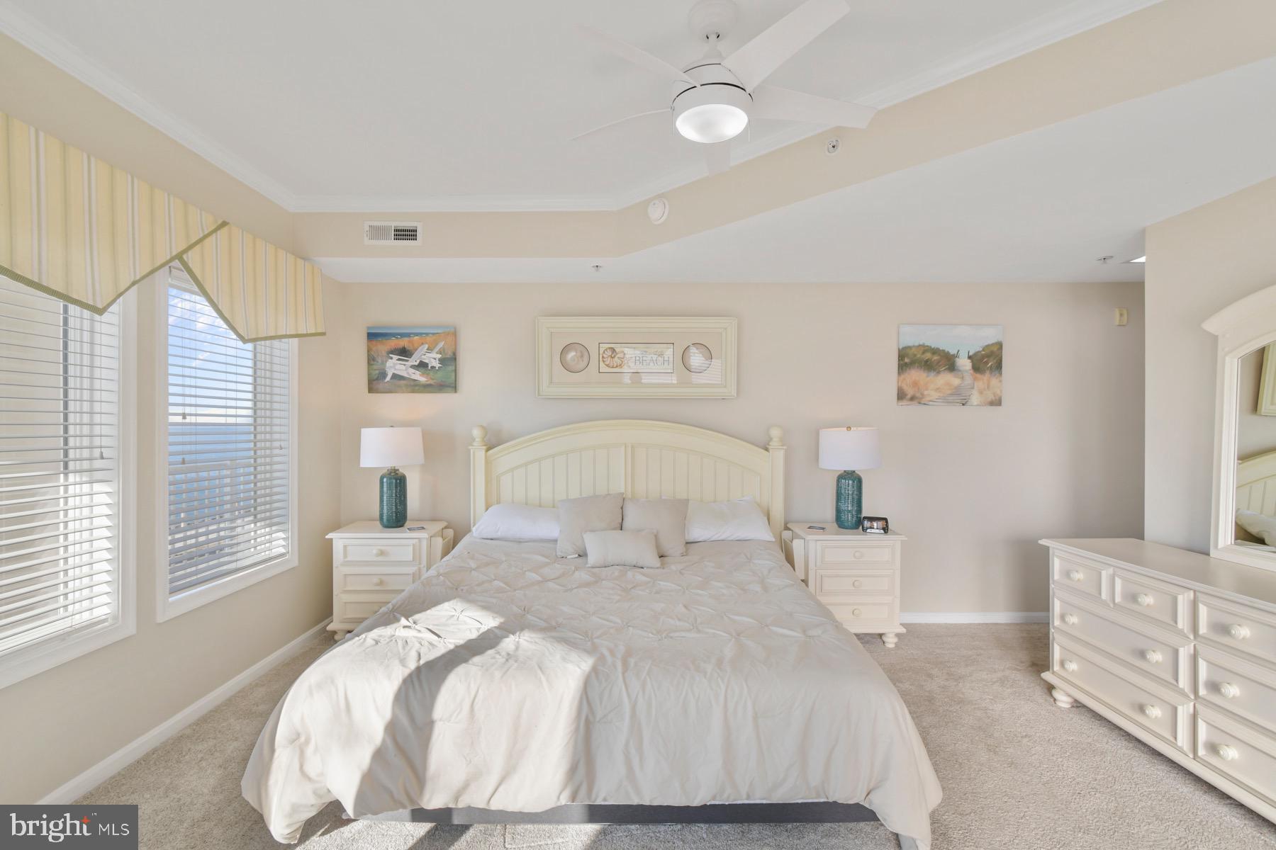 310 2nd Street, Unit 101 Ocean City, MD 21842 - Photo 14 of 37 a bed room with a bed and a couch