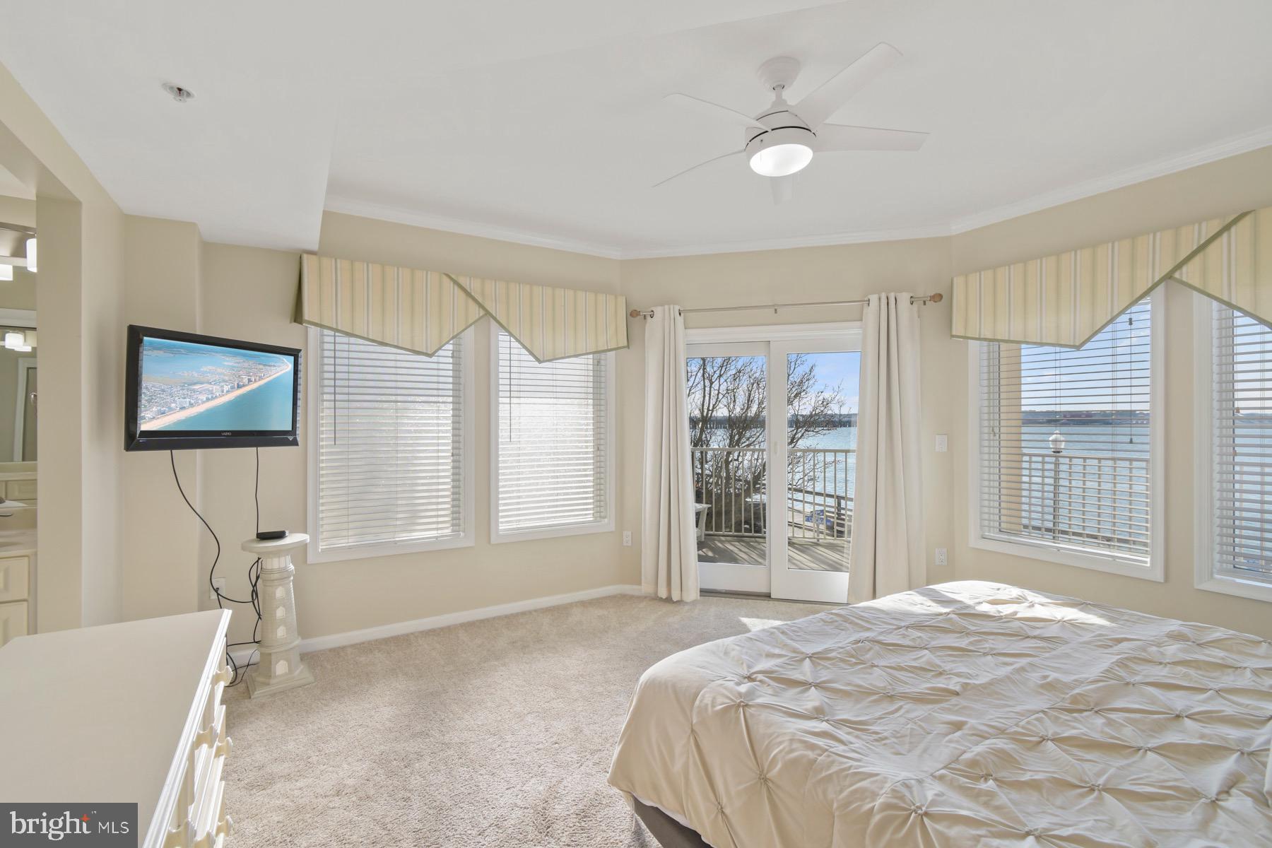 310 2nd Street, Unit 101 Ocean City, MD 21842 - Photo 15 of 37 a spacious bedroom with a large bed and a window