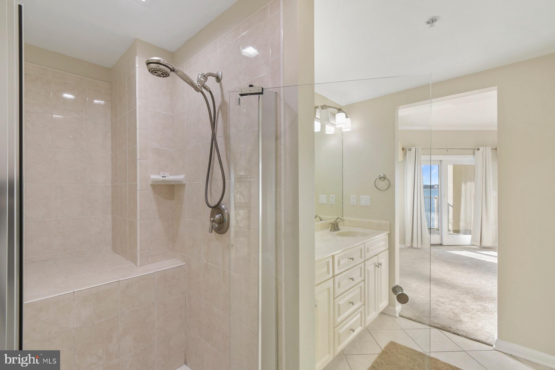 310 2nd Street, Unit 101 Ocean City, MD 21842 - Photo 17 of 37 a bathroom with a glass shower door and a sink