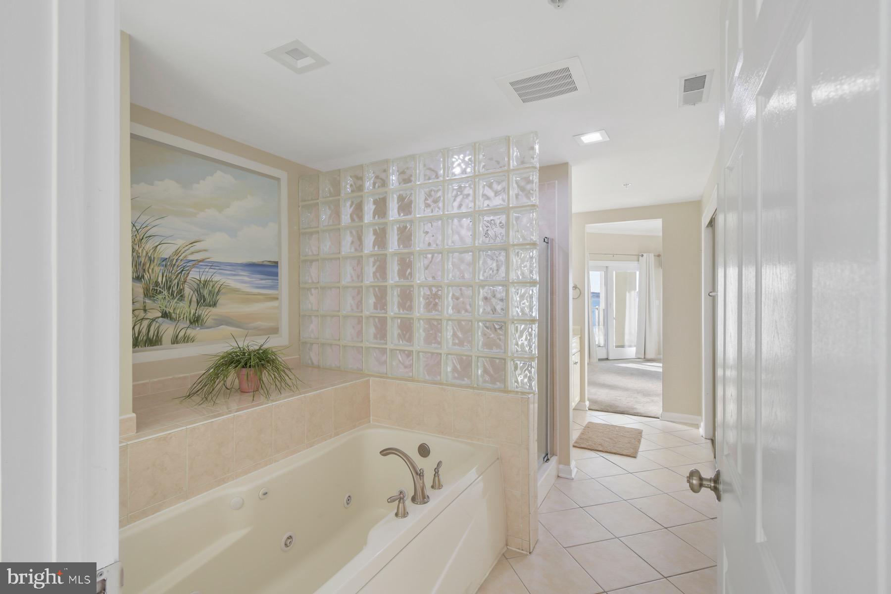 310 2nd Street, Unit 101 Ocean City, MD 21842 - Photo 18 of 37 a bathroom with a bathtub and shower