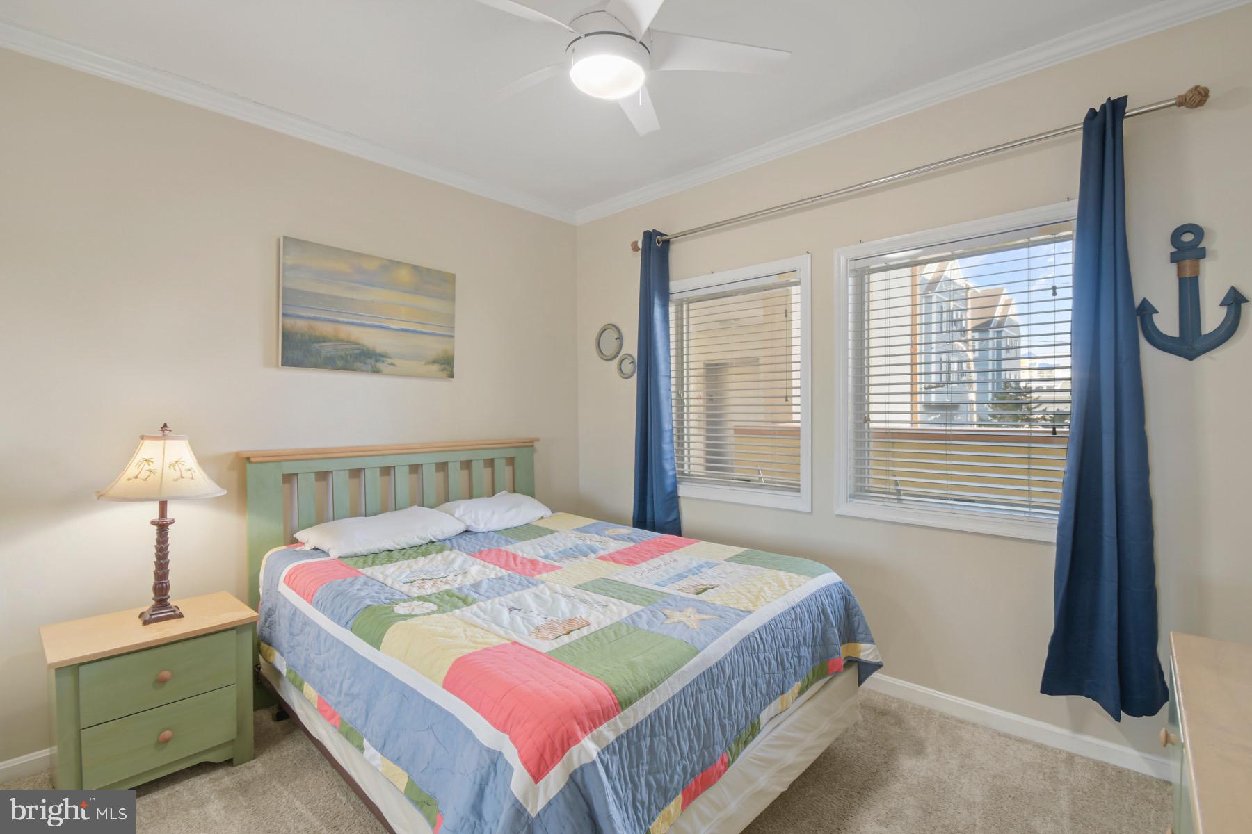 310 2nd Street, Unit 101 Ocean City, MD 21842 - Photo 19 of 37 a bedroom with a bed and a window