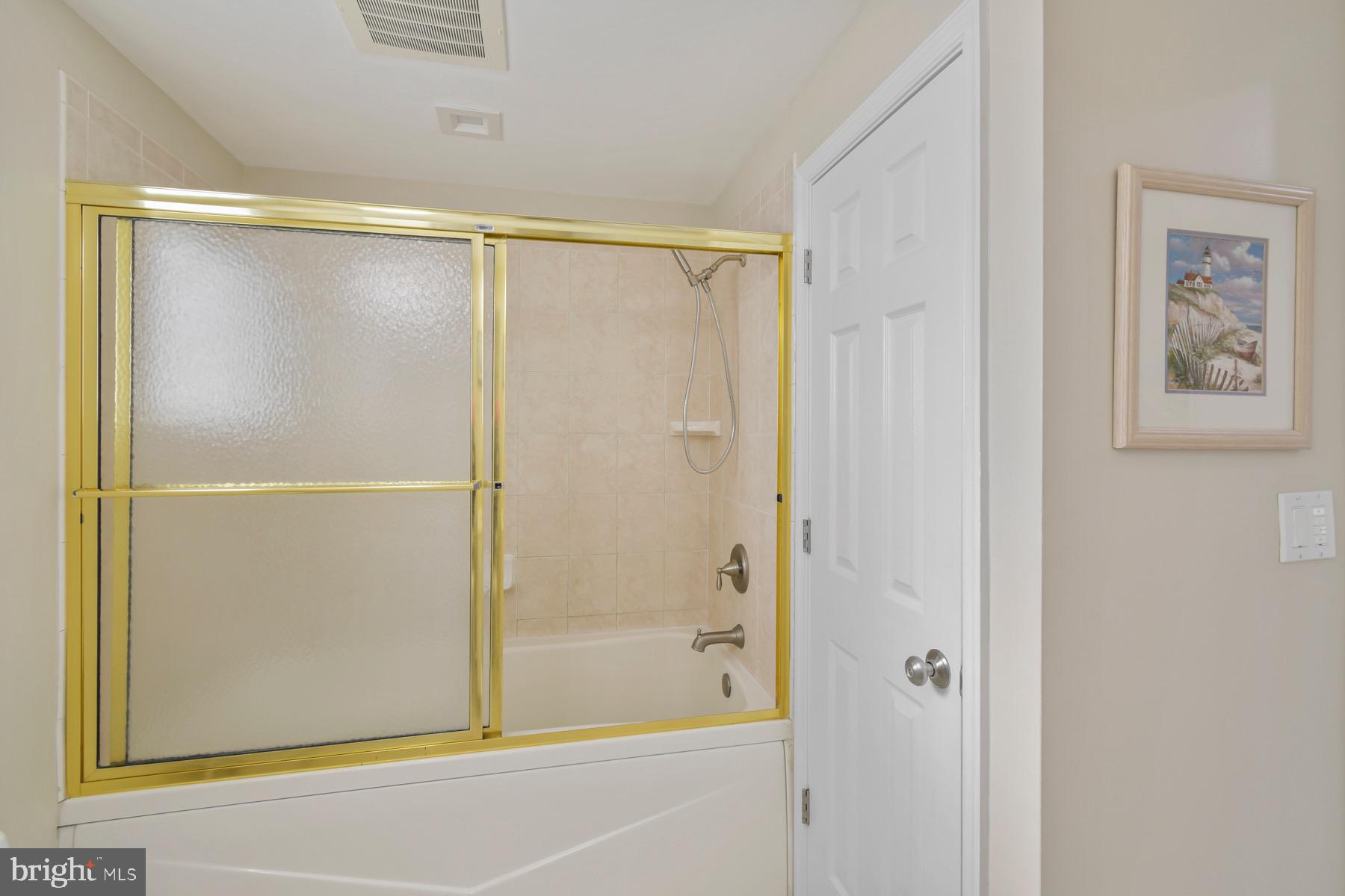 310 2nd Street, Unit 101 Ocean City, MD 21842 - Photo 24 of 37 a bathroom with a glass shower door