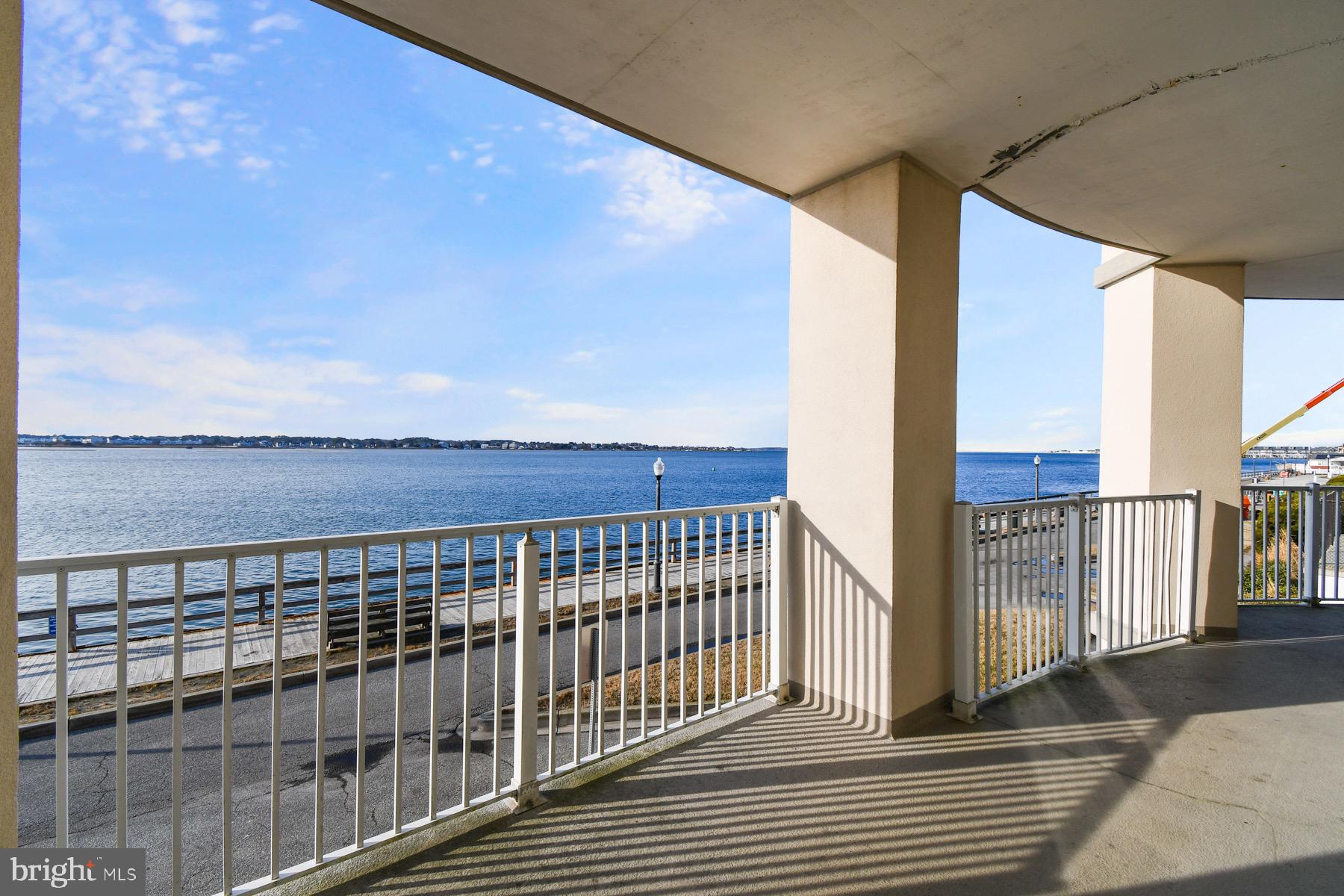 310 2nd Street, Unit 101 Ocean City, MD 21842 - Photo 29 of 37 a view of a balcony with wooden floor and fence