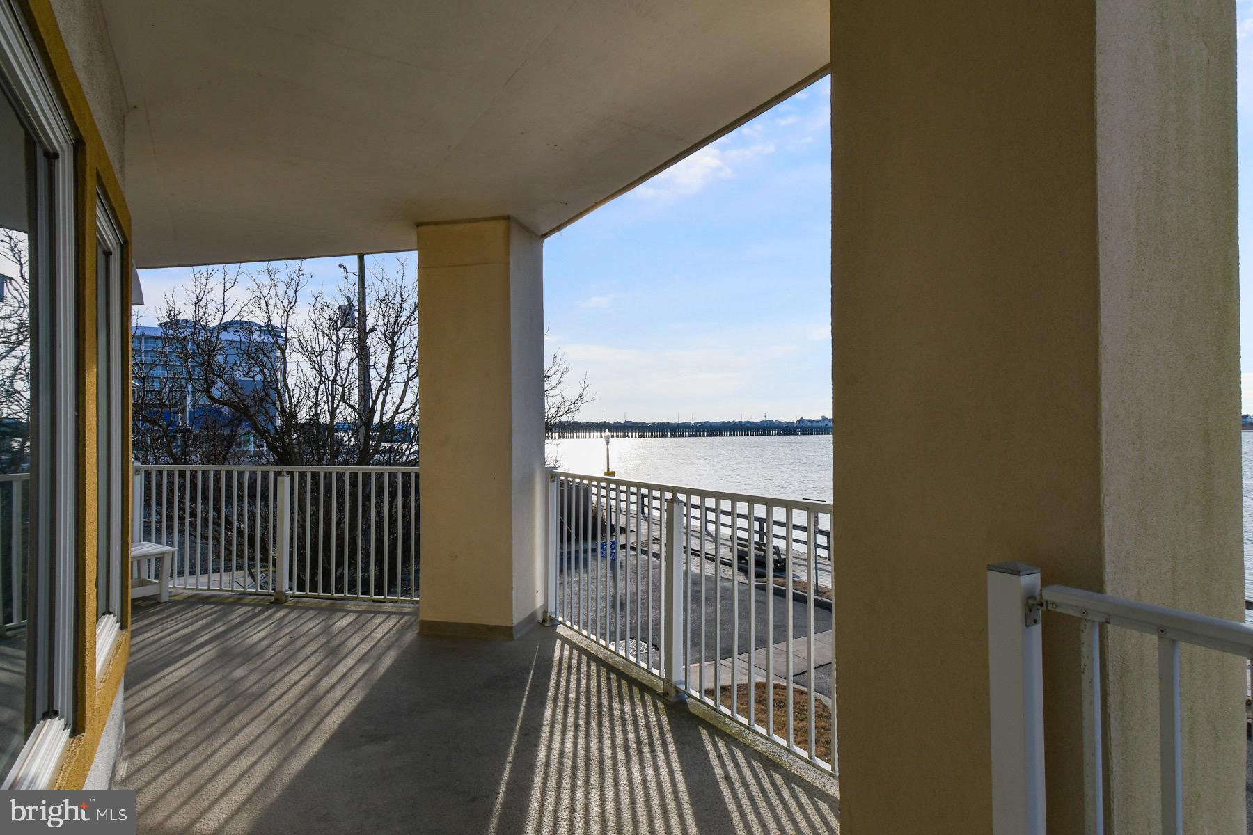 310 2nd Street, Unit 101 Ocean City, MD 21842 - Photo 31 of 37 a view of a balcony with wooden floor
