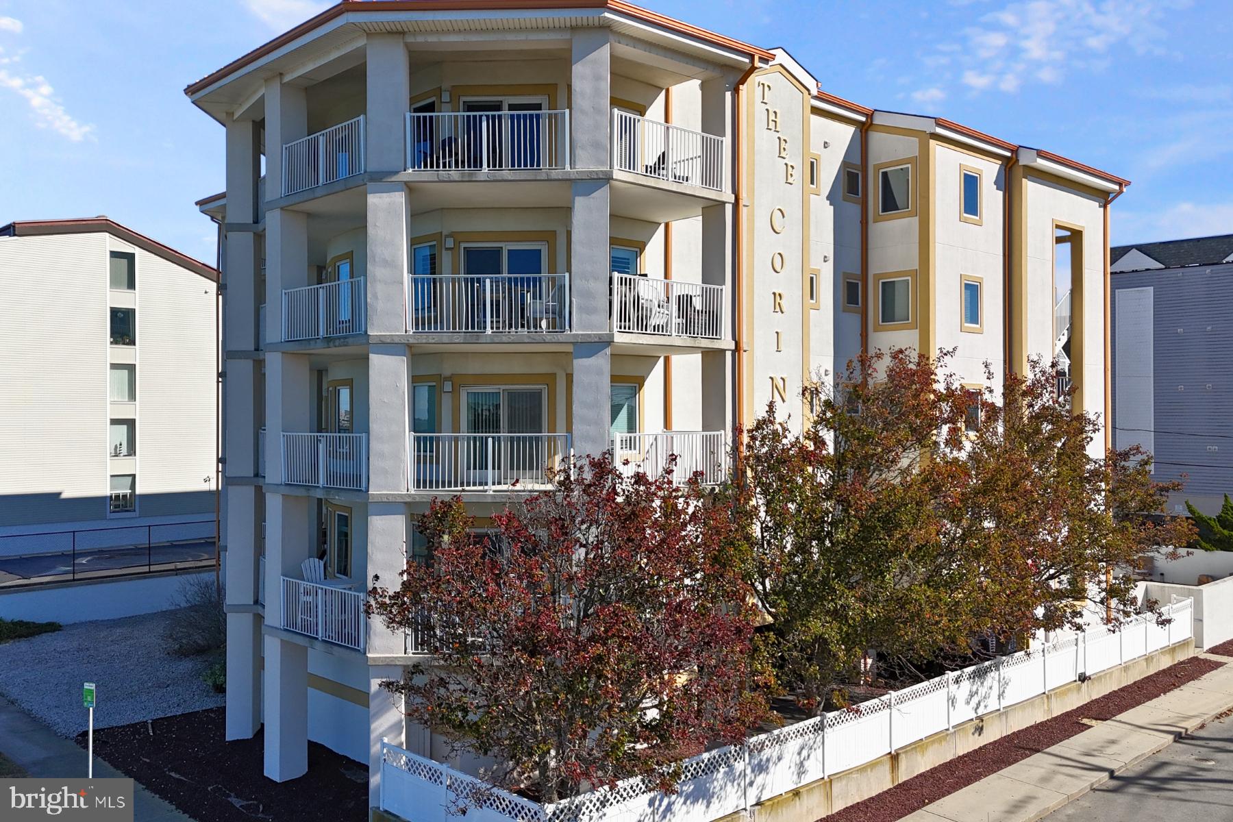 310 2nd Street, Unit 101 Ocean City, MD 21842 - Photo 32 of 37 a front view of a multi story residential apartment building with a yard