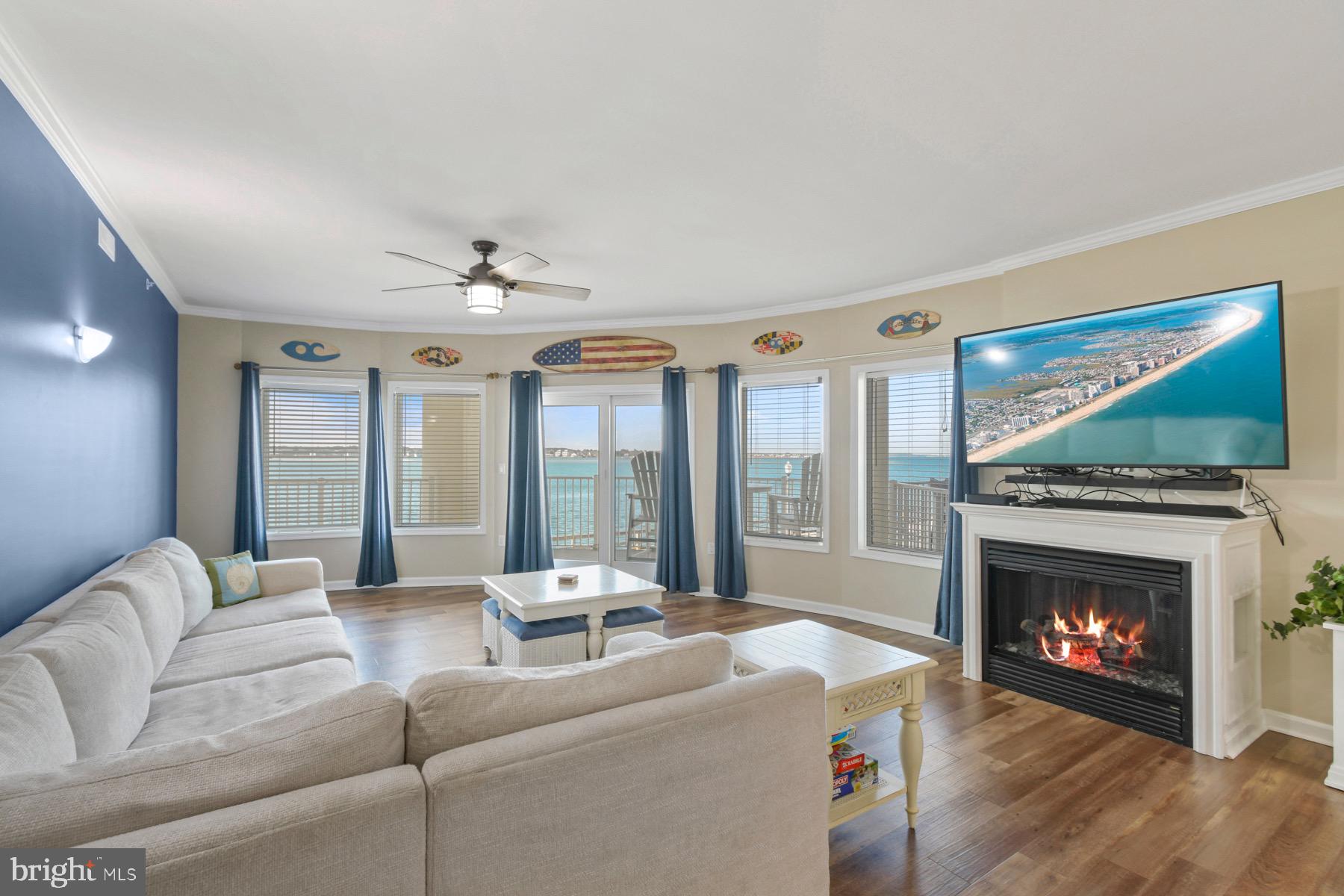 310 2nd Street, Unit 101 Ocean City, MD 21842 - Photo 4 of 37 a living room with furniture a flat screen tv and a fireplace