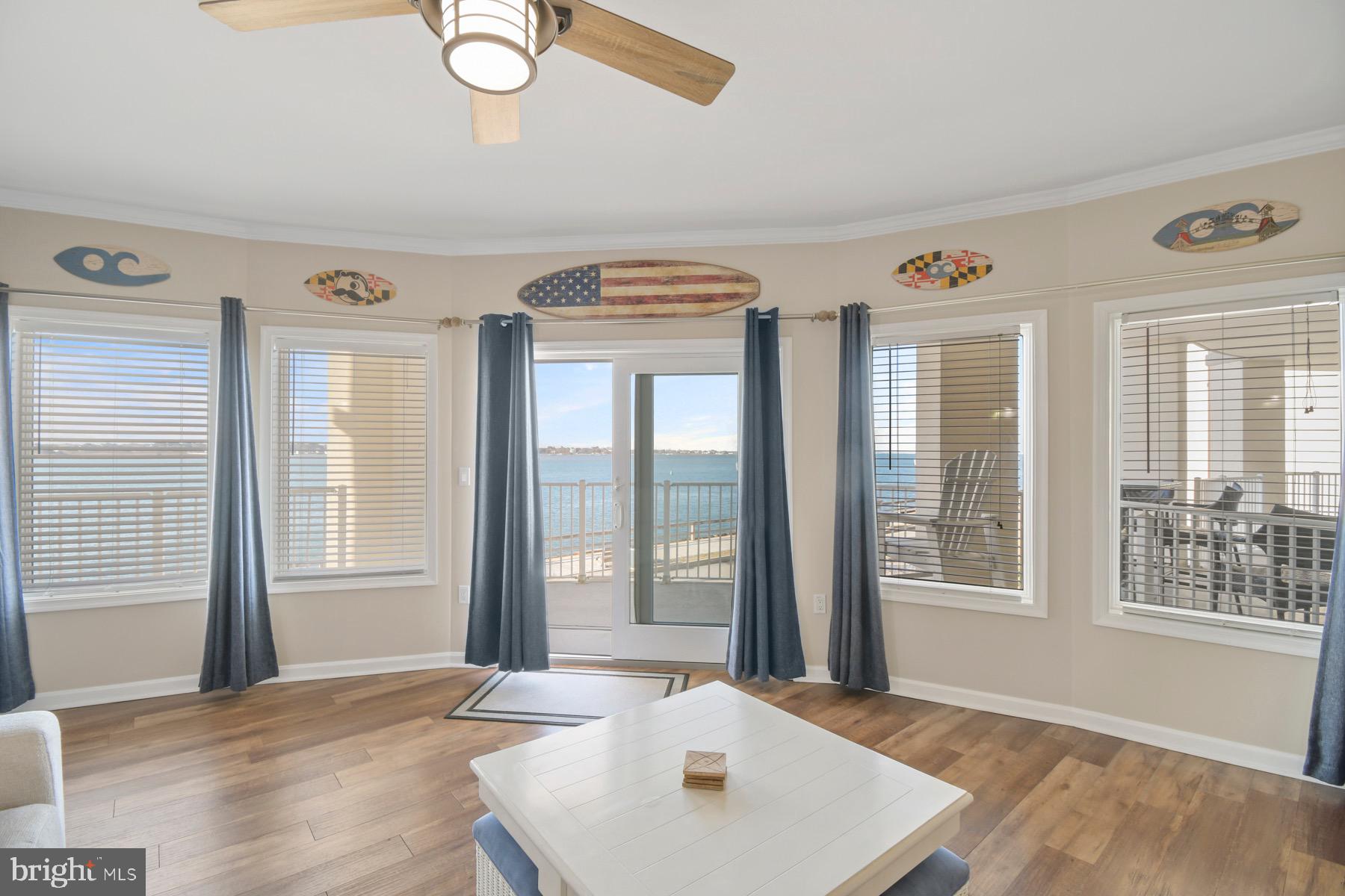 310 2nd Street, Unit 101 Ocean City, MD 21842 - Photo 6 of 37 a view of a bedroom with wooden floor and windows