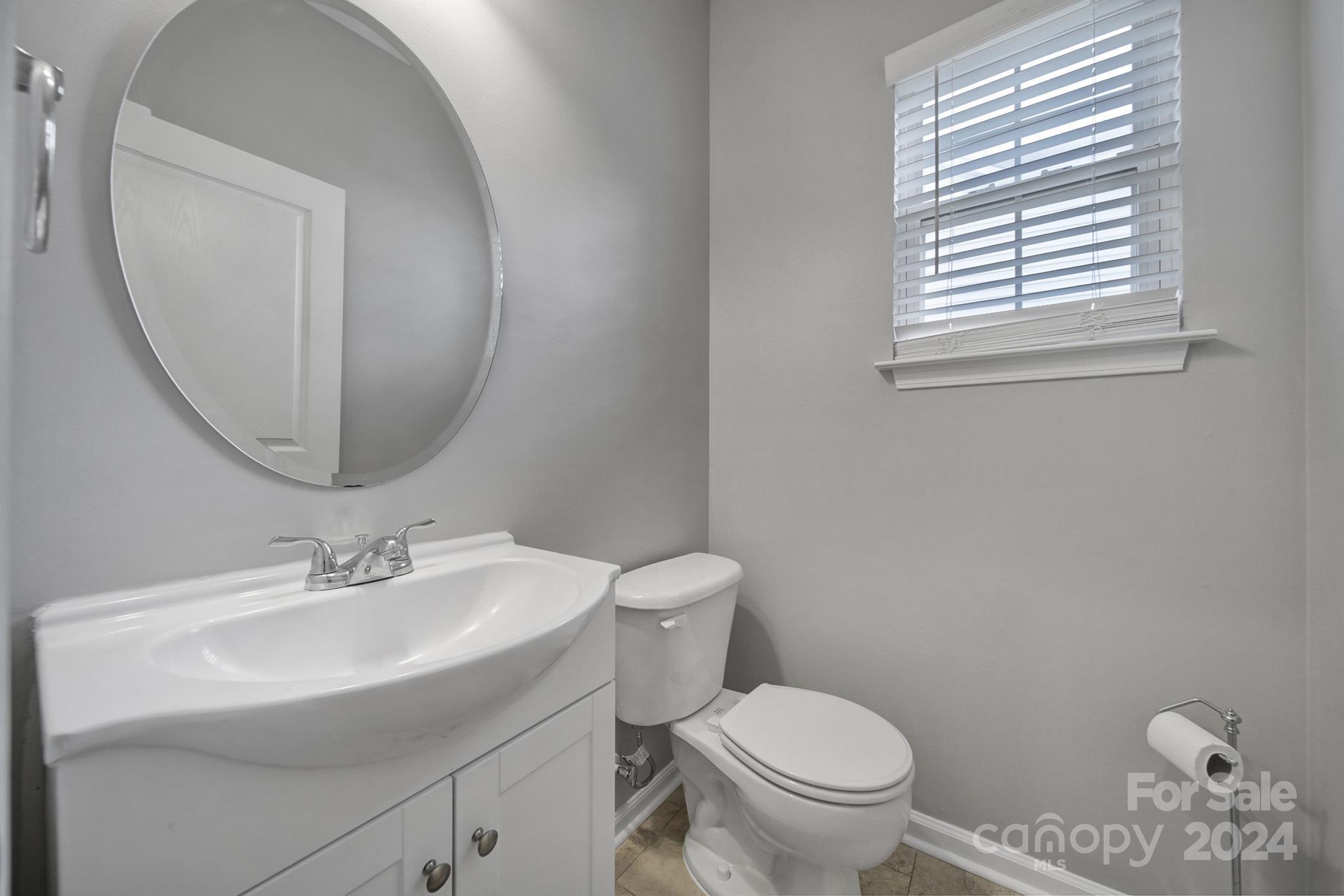 3305 Adair Marble Street Fort Mill, SC 29708 - Photo 11 of 38 a bathroom with a toilet a sink and mirror