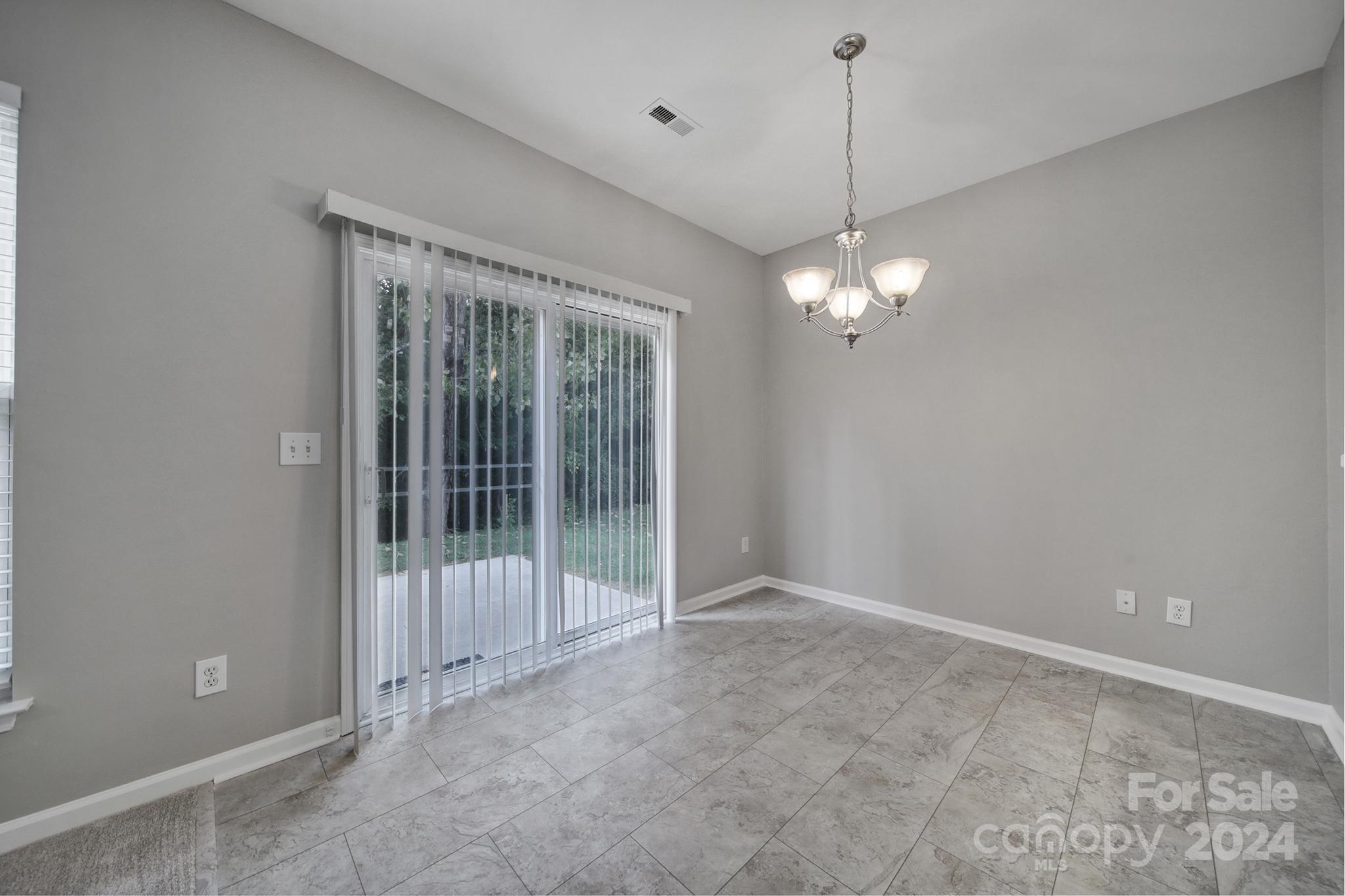 3305 Adair Marble Street Fort Mill, SC 29708 - Photo 15 of 38 a view of a room with a chandelier fan and a window