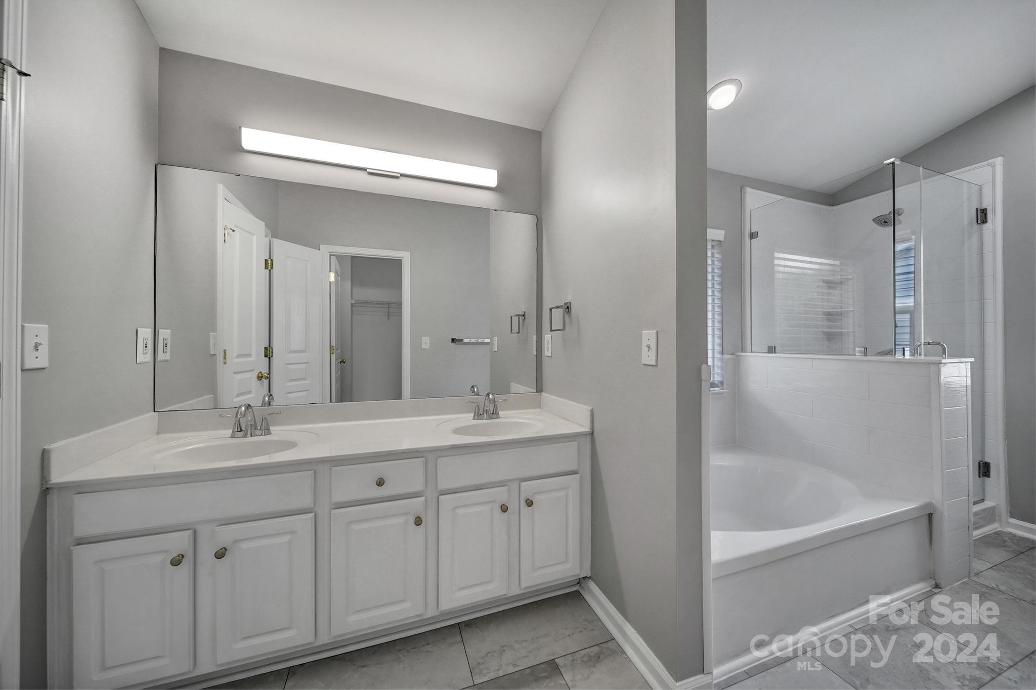 3305 Adair Marble Street Fort Mill, SC 29708 - Photo 19 of 38 a bathroom with a tub a sink double vanity and mirror