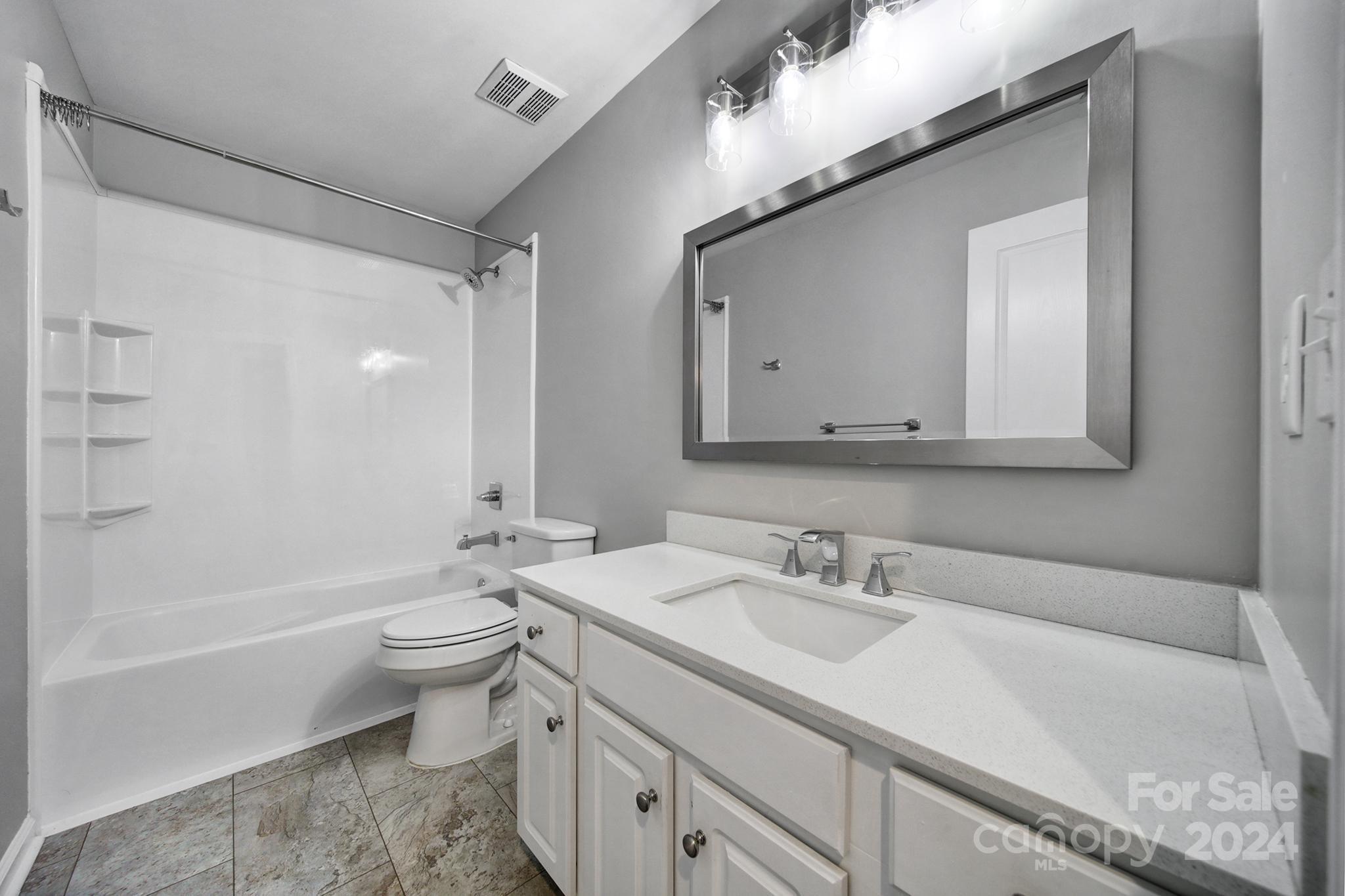 3305 Adair Marble Street Fort Mill, SC 29708 - Photo 23 of 38 a bathroom with a granite countertop sink toilet and shower