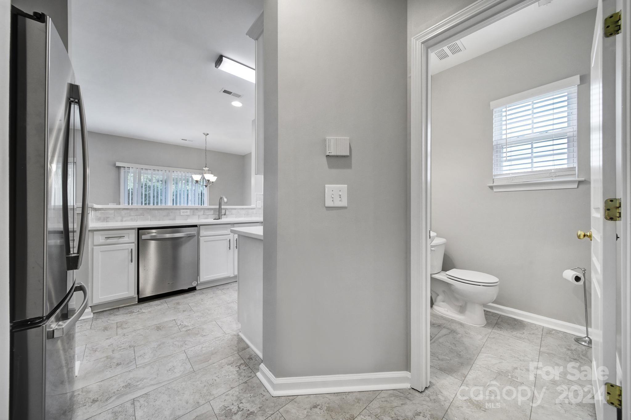 3305 Adair Marble Street Fort Mill, SC 29708 - Photo 6 of 38 a bathroom with a granite countertop toilet sink and a mirror