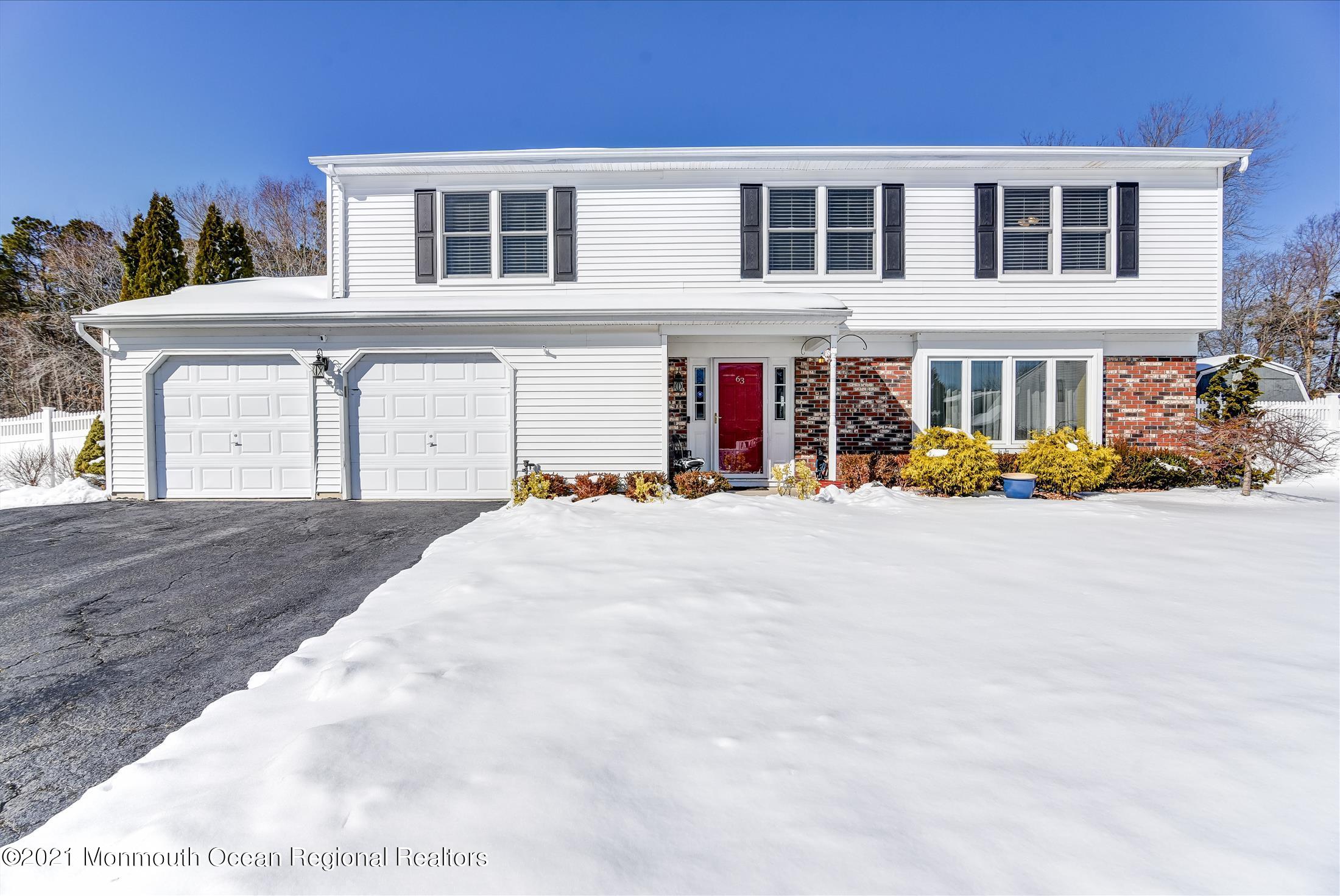 63 Hedgewood Road Howell, NJ 07731 - Photo 1 of 25 a front view of a house with a yard
