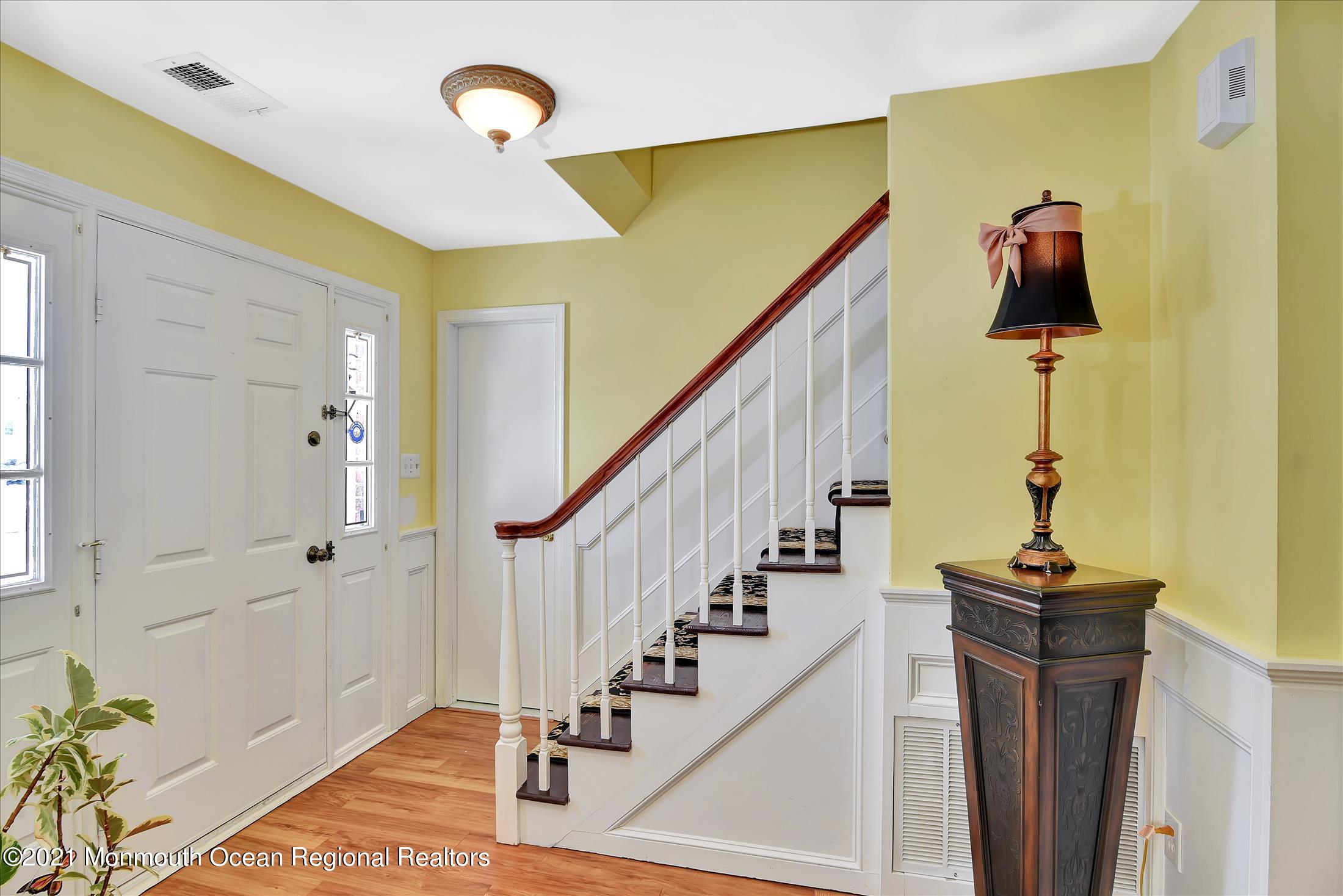63 Hedgewood Road Howell, NJ 07731 - Photo 2 of 25 a view of a hallway with wooden floor and staircase