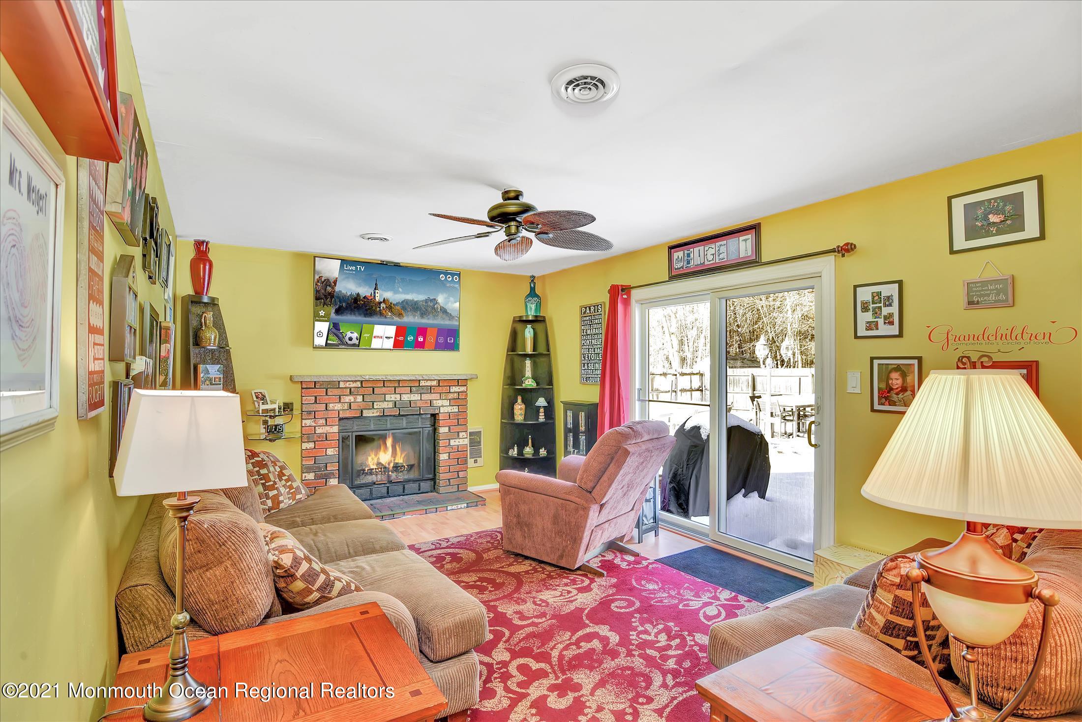 63 Hedgewood Road Howell, NJ 07731 - Photo 11 of 25 a living room with furniture and a fireplace