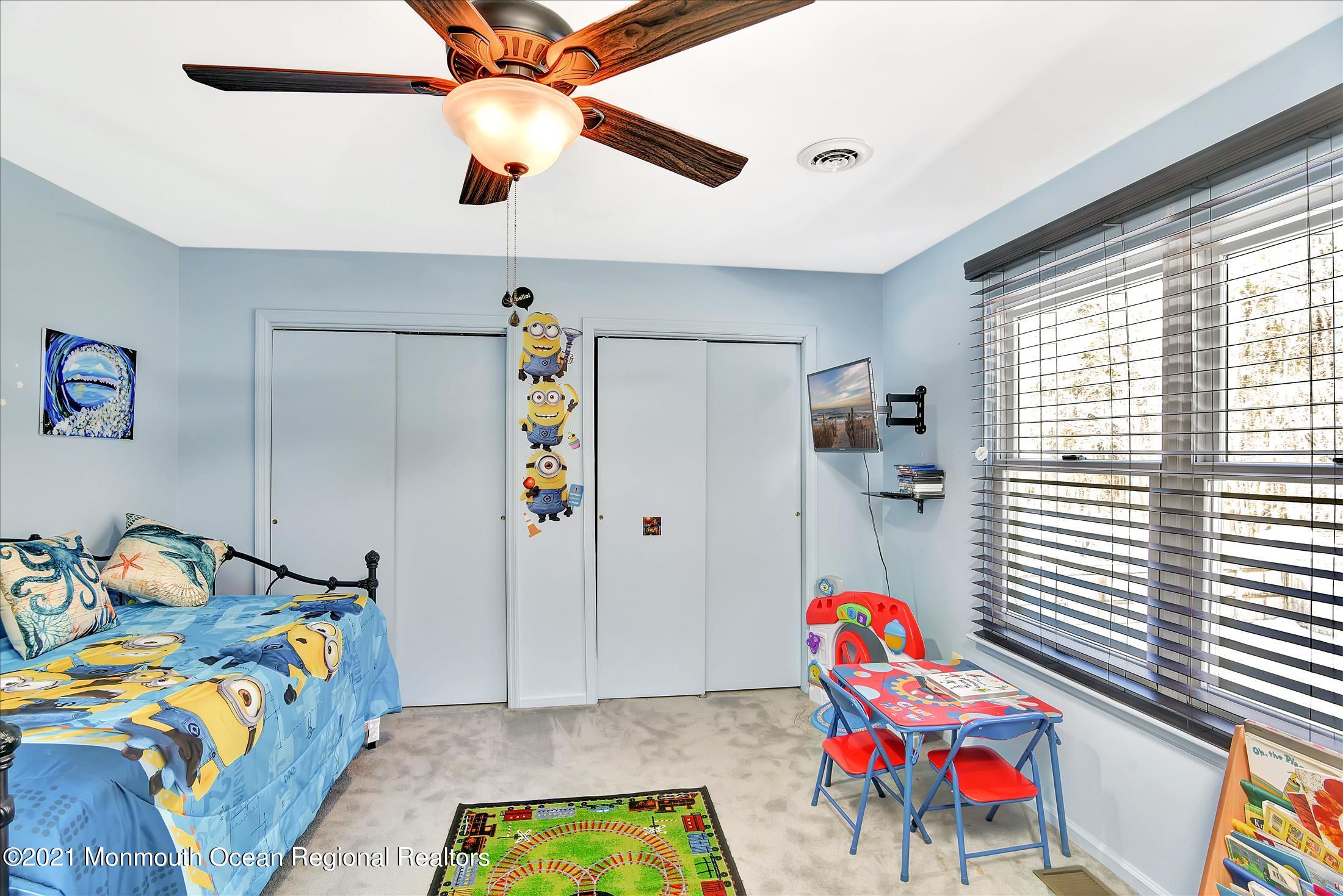 63 Hedgewood Road Howell, NJ 07731 - Photo 13 of 25 a bedroom with a bed and a chandelier